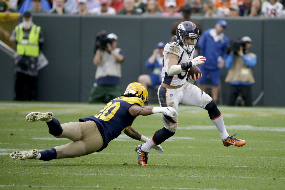 Denver Broncos running back Phillip Lindsay, right, runs with the ball as Green Bay Packers cornerback Kevin King (20) defends during the second half of an NFL football game Sunday, Sept. 22, 2019, in Green Bay, Wis. (AP Photo/Mike Roemer)