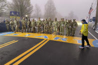 Boston Marathon Race Director Dave McGillivray sends out a group of about 20 from the Massachusetts National Guard, which walks the course annually, announcing the start of the 127th marathon Monday, April 17, 2018. (AP Photo/Jennifer McDermott)
