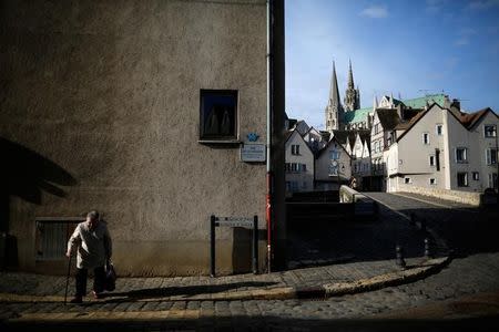 A woman crosses the street in Chartres, France February 3, 2017. REUTERS/Stephane Mahe