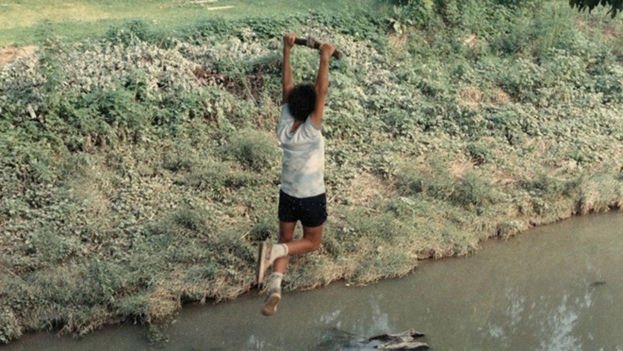 A kid on a swing near coldwater creek