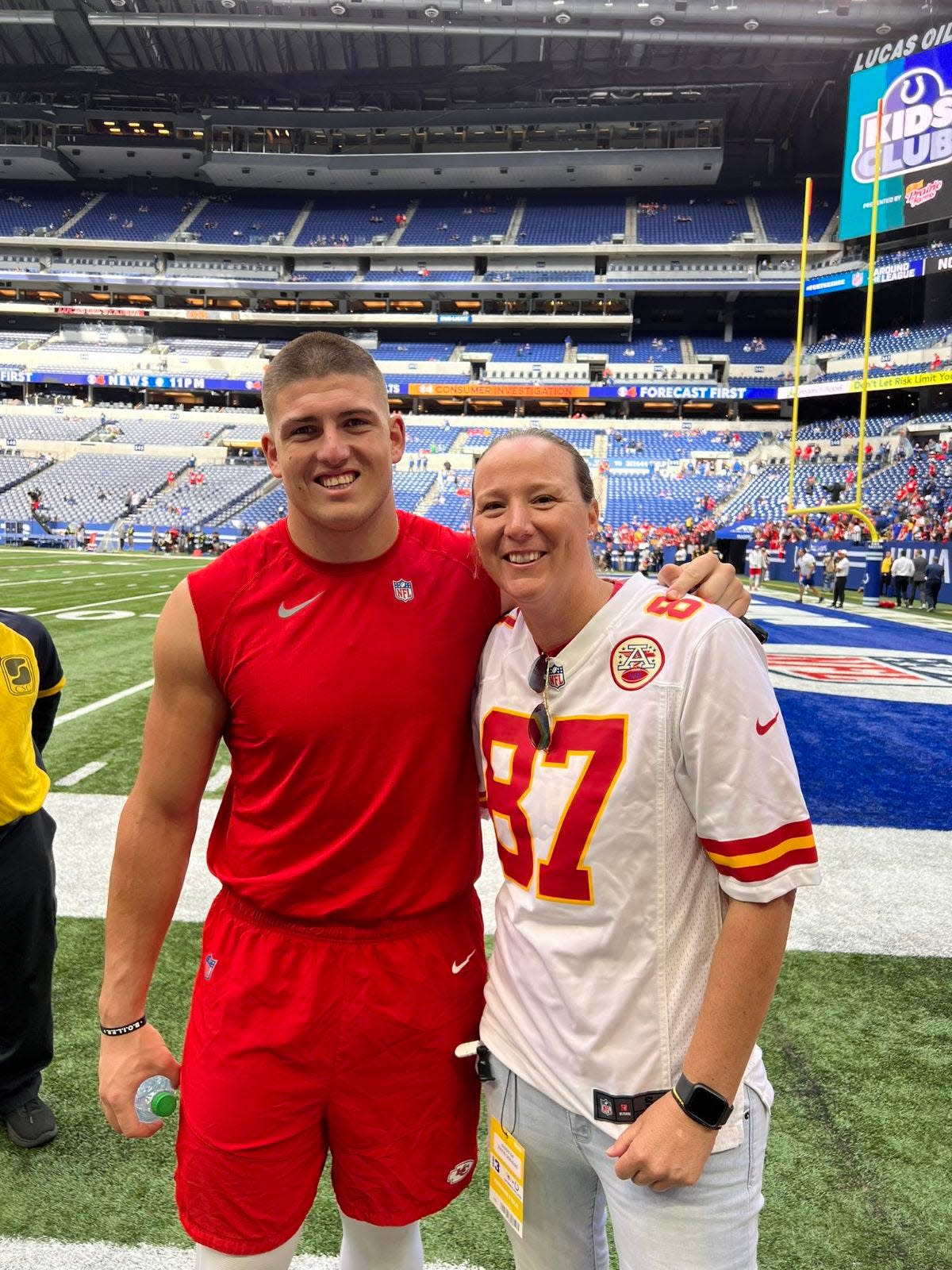 Purdue women's basketball coach Katie Gearlds (right) is shown sharing a smile with Kansas City Chiefs defensive end George Karlaftis.