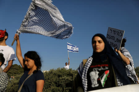 Left-wing activists take part in a protest in solidarity with Palestinians living in Gaza, next to the Gaza-Israel border, near Kibbutz Nahal Oz, Israel March 31, 2018. REUTERS/Ammar Awad