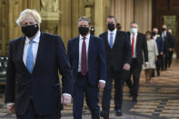 Britain's Prime Minister Boris Johnson, left, and Labour Party leader Keir Starmer, second left, walk through the Central Lobby on the way to the House of Lords prior to Queen Elizabeth II delivering a speech during the State Opening of Parliament in the House of Lords at the Palace of Westminster in London, Tuesday May 11, 2021. (Stefan Rousseau/Pool via AP)