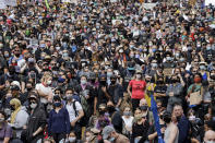 Peaceful protesters fill a street adjacent to Seattle City Hall Wednesday, June 3, 2020, in Seattle, following protests over the death of George Floyd, a black man who was in police custody in Minneapolis. (AP Photo/Elaine Thompson)