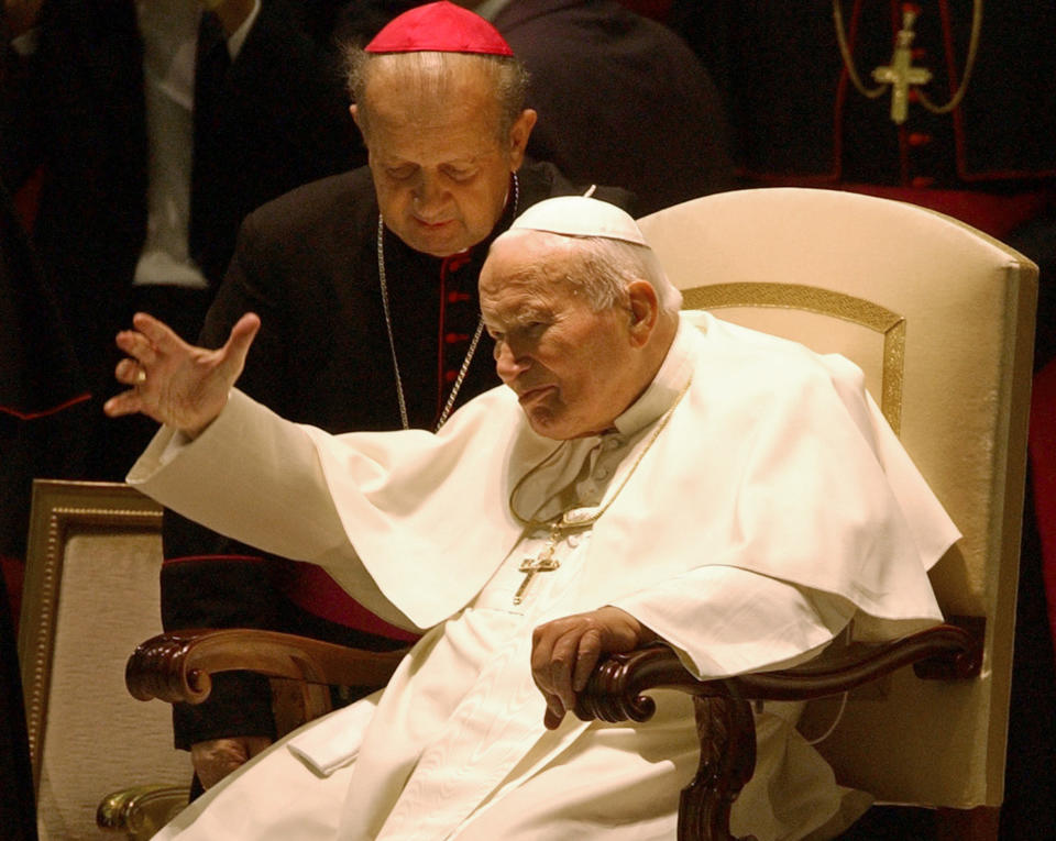 FILE - A Thursday, Oct. 16, 2003 photo from files showing Pope John Paul II with Archbishop Stanislaw Dziwisz as he arrives in the Paul VI hall to hear a "Message from the College of Cardinals to the Holy Father" at the Vatican. Pope John Paul II's secretary "did not have the courage" to burn all of the pontiff's notes after his death, and is now having some of them published, he said Wednesday, Jan. 22, 2014. The book, "Very Much in God's Hands," comes out Feb. 5 in Poland, where the pope is still a much-loved authority. It contains religious meditations that Karol Wojtyla recorded between July 1962, when he was a bishop in Poland, and March 2003, when he was pope. (AP Photo/Plinio Lepri, File)