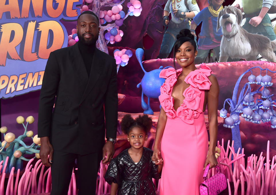 LOS ANGELES, CALIFORNIA - NOVEMBER 15: (L-R) Dwyane Wade, Kaavia James Union Wade, and Gabrielle Union attend the world premiere of Walt Disney Animation Studios'  Strange World at El Capitan Theatre in Hollywood, California on November 15, 2022. (Photo by Alberto E. Rodriguez/Getty Images for Disney)