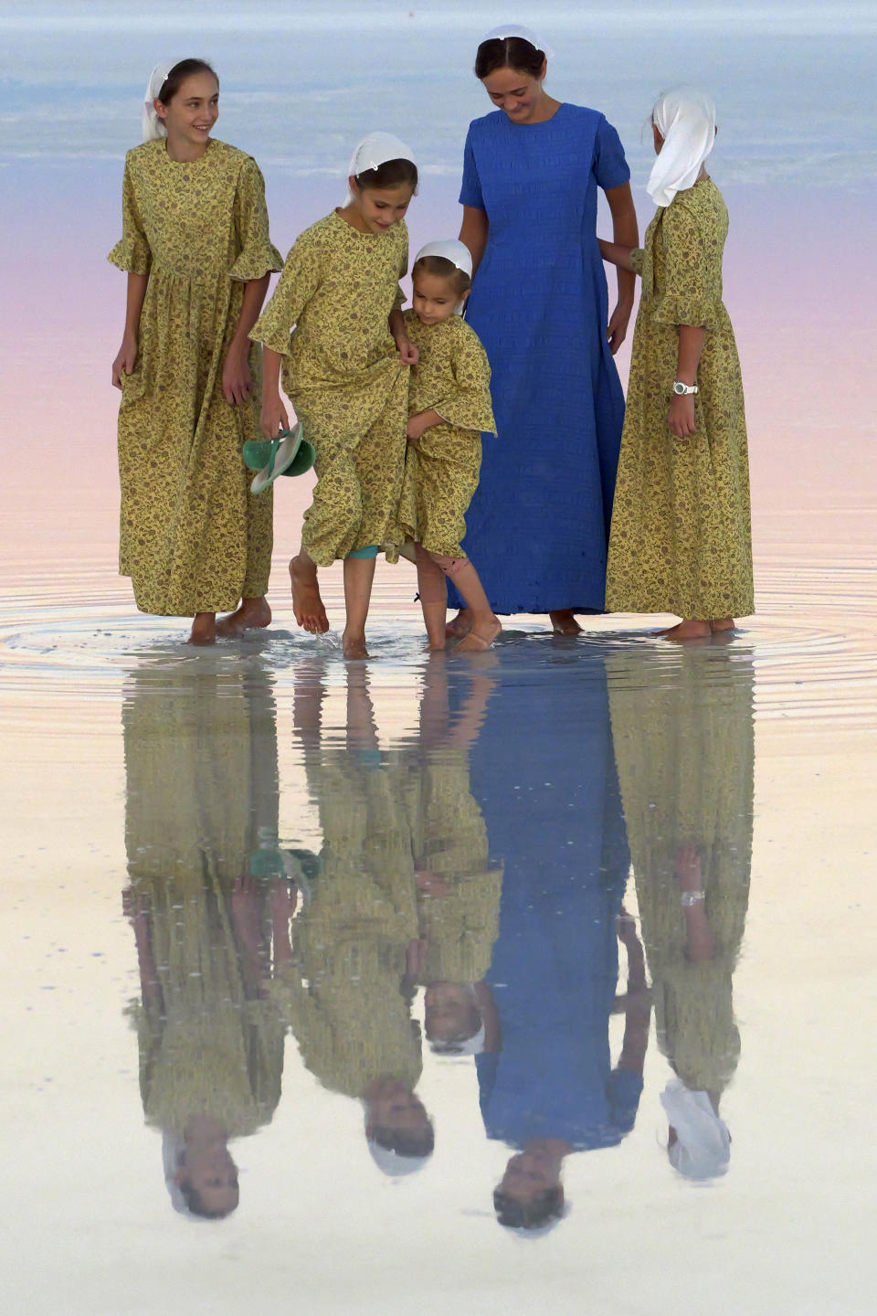 Visitors pose for a photograph at the Bonneville Salt Flats on Friday, Oct. 7, 2022, near Wendover, Utah. (AP Photo/Rick Bowmer)