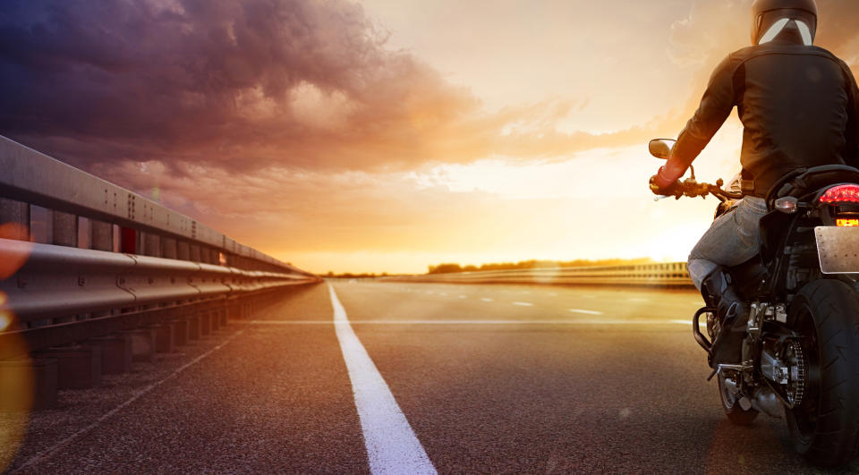 Motorcycle on roadway at sunset