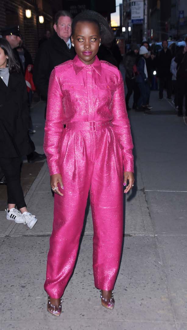 <p>Continuing to channel onscreen character Red in new horror flick, ‘Us’, the actress wore spooky contacts once again. This time, she opted for a hot pink jumpsuit by Bande Noir finished with Sergio Rossi heels. <em>[Photo: Getty]</em> </p>