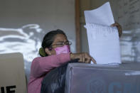 A voter casts her ballot during general elections in Tegucigalpa, Honduras, Sunday, Nov. 28, 2021. (AP Photo/Moises Castillo)