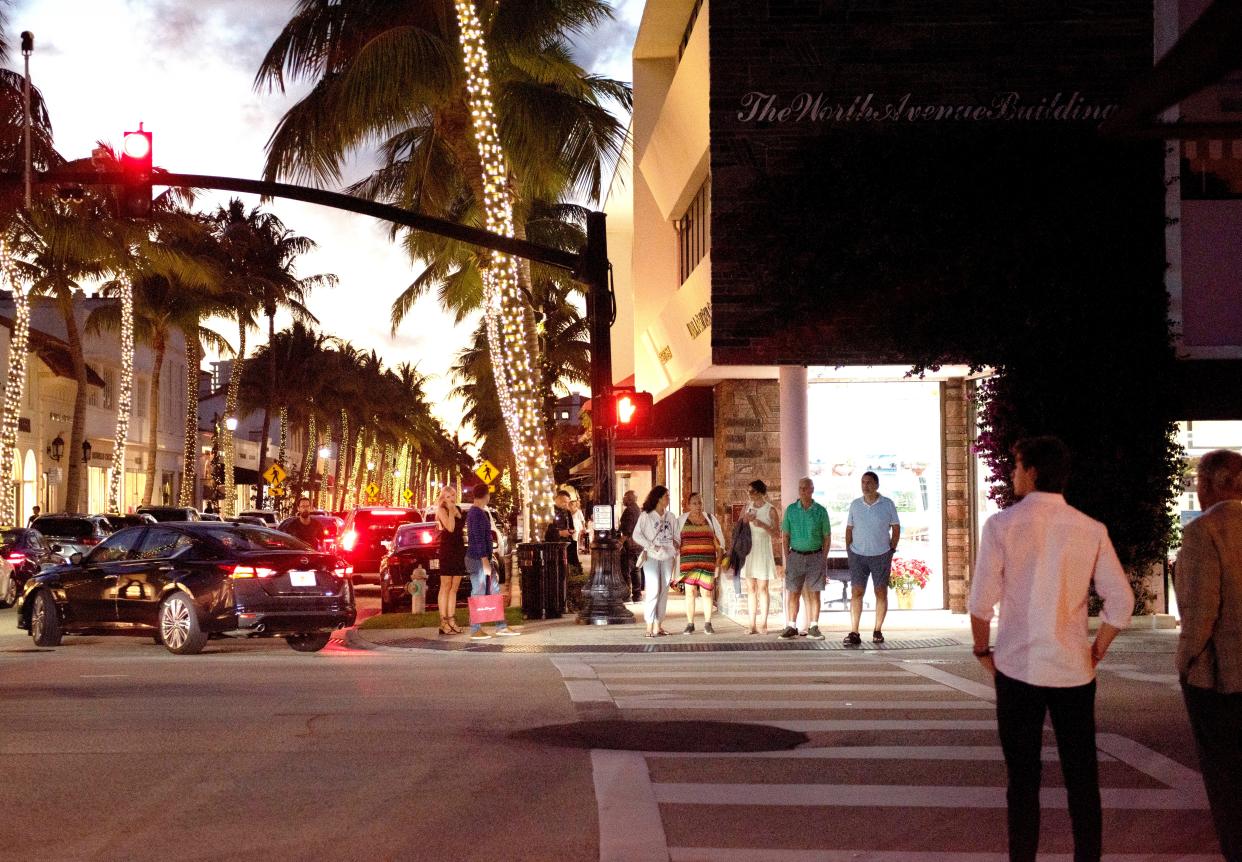 Pedestrians walk along Worth Avenue and South County Road. Retailers say new customers have boosted business.