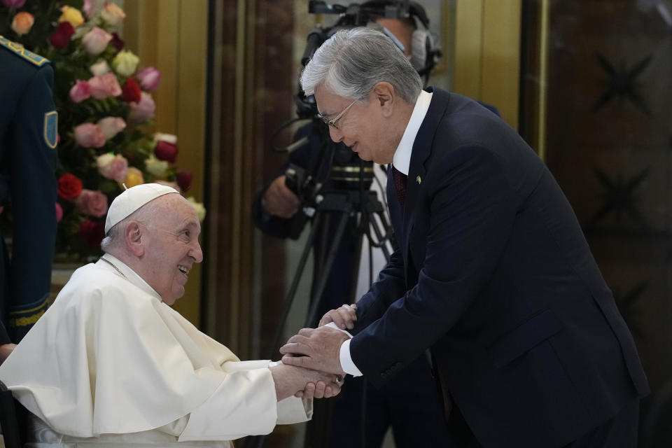 Pope Francis, left, meets the Kazakhstan's President Kassym-Jomart Tokayev as he arrives at Our-Sultan's International airport in Nur-Sultan, Kazakhstan, Tuesday, Sept. 13, 2022. Pope Francis begins a 3-days visit to the majority-Muslim former Soviet republic to minister to its tiny Catholic community and participate in a Kazakh-sponsored conference of world religious leaders. (AP Photo/Andrew Medichini)