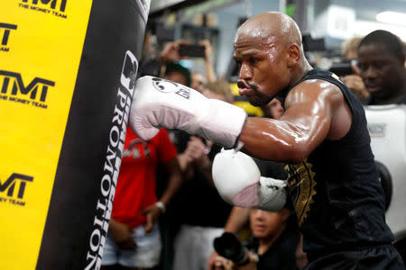 FILE PHOTO - Floyd Mayweather Jr. of the U.S. hits a heavy bag during a workout at the Mayweather Boxing Club in Las Vegas, Nevada, U.S., August 10, 2017. REUTERS/Las Vegas Sun/Steve Marcus