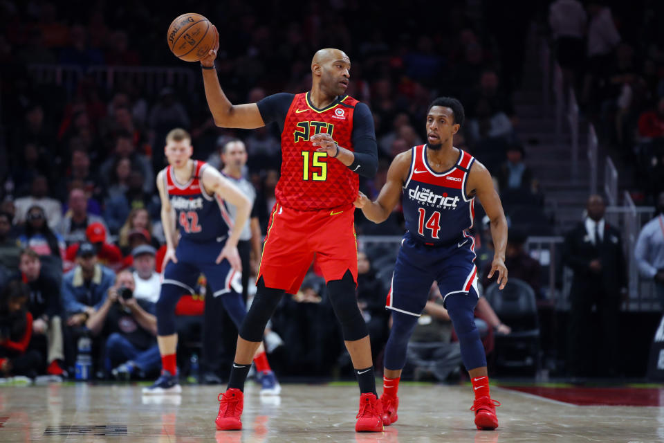 Atlanta Hawks guard Vince Carter (15) looks to pass as Washington Wizards guard Ish Smith (14) defends during the second half of an NBA basketball game on Sunday, Jan. 26, 2020, in Atlanta. (AP Photo/Todd Kirkland)