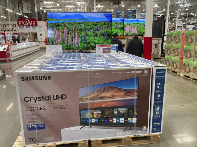 Shoppers pass by a display of big-screen televisions in a Costco warehouse Wednesday, April 26, 2023, in Sheridan, Colo. On Tuesday, the Commerce Department releases U.S. retail sales data for April. (AP Photo/David Zalubowski)