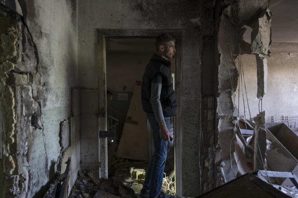 A man inspects his office damaged by a drone during a night attack, in Kyiv, Ukraine, Sunday, May 28, 2023. Ukraine's capital was subjected to the largest drone attack since the start of Russia's war, local officials said, as Kyiv prepared to mark the anniversary of its founding on Sunday. (AP Photo/Vasilisa Stepanenko)