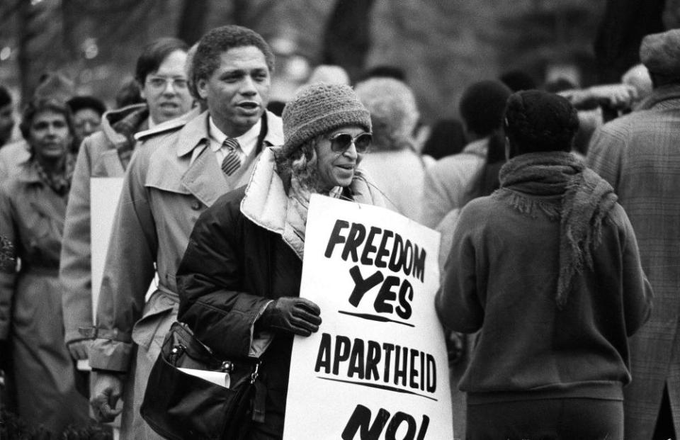 Rosa Parks joins in a march against apartheid at the South African embassy in Washington in 1984.