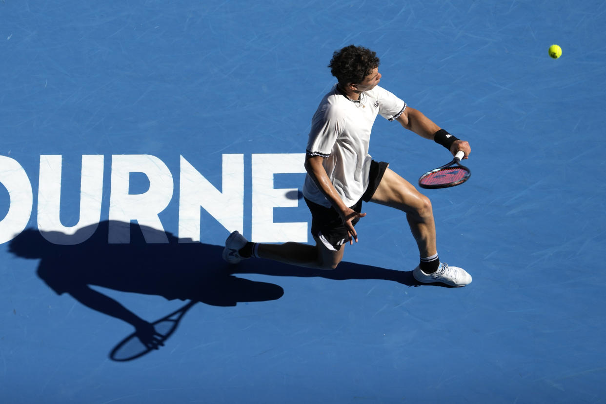 Ben Shelton of the U.S. plays a backhand return to compatriot Tommy Paul during their quarterfinal match at the Australian Open tennis championship in Melbourne, Australia, Wednesday, Jan. 25, 2023. (AP Photo/Ng Han Guan)