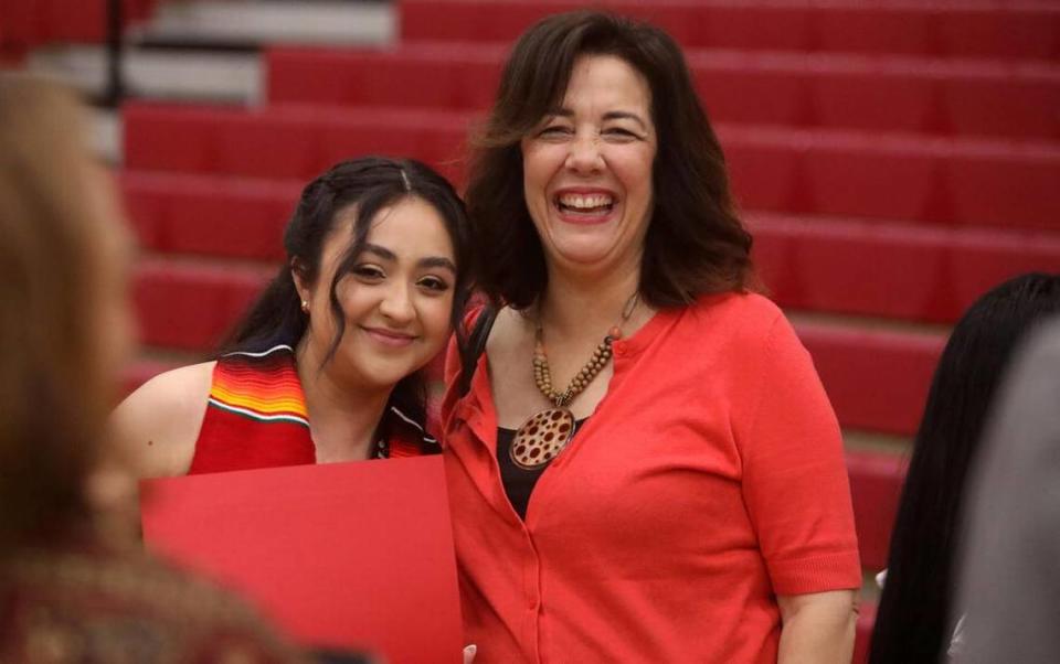 Graduate Valentina López Meza gets a hug from Edison High intructor Carol Padilla-Shaath at the 21st Latino Graduation Celebration at the college gym on May 6, 2023.