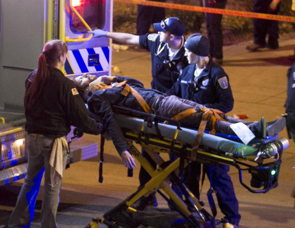 A man is transported to an ambulance after being struck by a vehicle on Red River Street in downtown Austin, Texas, on Wednesday March 12, 2014. Police say two people were confirmed dead at the scene after a car drove through temporary barricades set up for the South By Southwest festival and struck a crowd of pedestrians. The condition of the man is unknown. (AP Photo/Austin American-Statesman, Jay Janner)