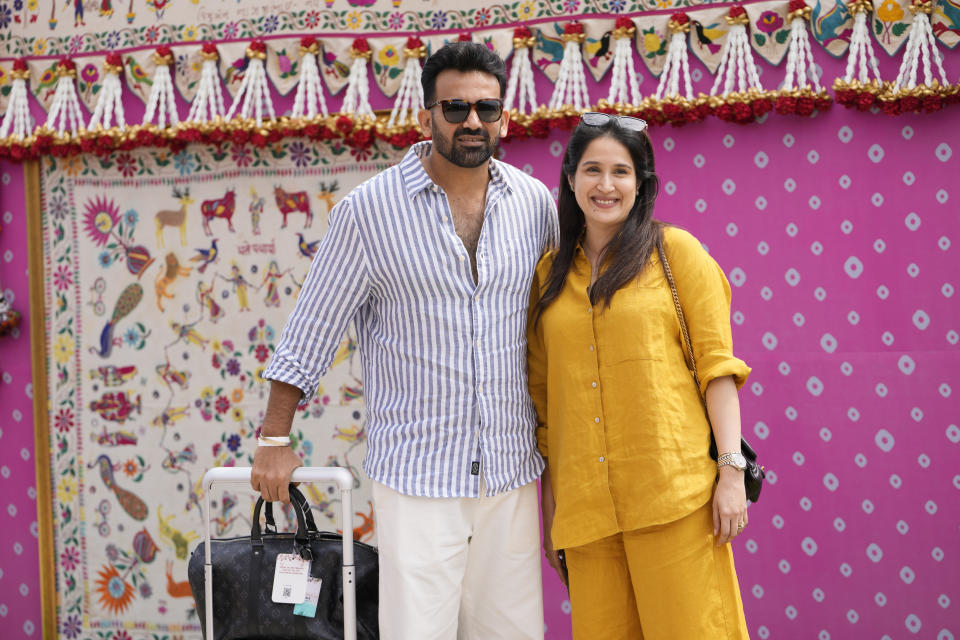 Former Indian cricketer Zaheer Khan, left, and his wife Sagarika Ghatge pose for a photograph as they arrive to attend a pre-wedding bash of billionaire industrialist Mukesh Ambani's son Anant Ambani, in Jamnagar, India, Friday, March 1, 2024. (AP Photo/Ajit Solanki)