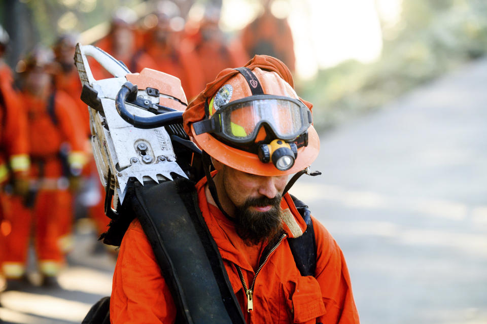 Inmate firefighters prepare to battle the Kincade Fire near Healdsburg, Calif., on Tuesday, Oct. 29, 2019. Millions of people have been without power for days as fire crews race to contain two major wind-whipped blazes that have destroyed dozens of homes at both ends of the state: in Sonoma County wine country and in the hills of Los Angeles. (AP Photo/Noah Berger)