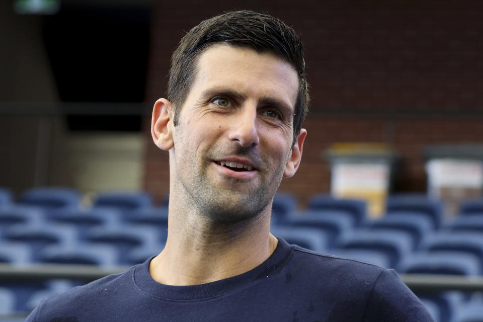 FILE - Serbia's Novak Djokovic addresses the media following a practice session ahead of the Adelaide International Tennis tournament in Adelaide, Australia, Thursday, Dec. 29, 2022. The 2023 Grand Slam season begins at the Australian Open next week. (AP Photo/Kelly Barnes, File)