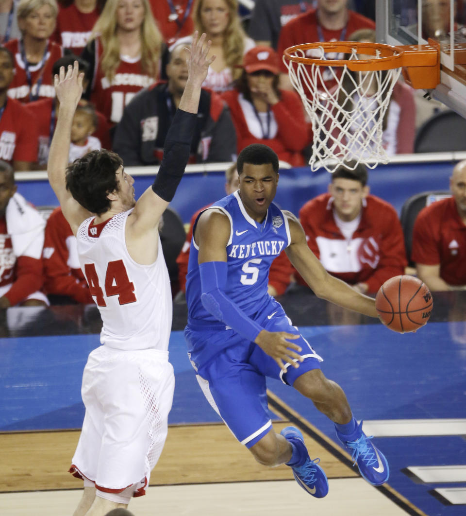 Kentucky guard Andrew Harrison, right, drives past Wisconsin forward Frank Kaminsky, left, during the first half of an NCAA Final Four tournament college basketball semifinal game Saturday, April 5, 2014, in Arlington, Texas. (AP Photo/Tony Gutierrez)