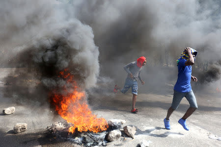 Demonstrators take part in a protest against former government officials accused of misusing Petrocaribe funds and the country's inflation rate in Port-au-Prince, Haiti February 7, 2019. REUTERS/Jeanty Junior Augustin