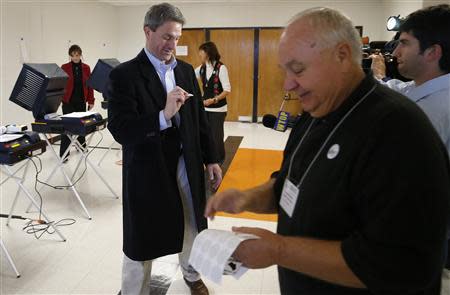 Virginia Republican gubernatorial nominee Ken Cuccinelli gets an "I Voted" sticker after casting his ballot at a polling place at Brentsville High School in Nokesville, Virginia, November 5, 2013. REUTERS/Jonathan Ernst