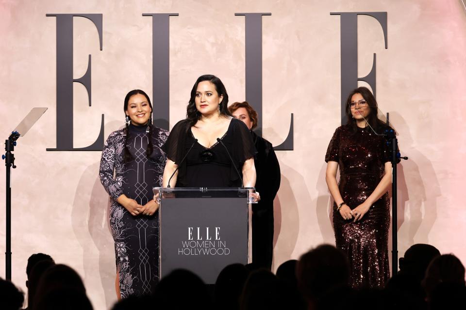 Lily Gladstone, center, accepts an award presented by Janae Collins, left, Julie O'Keefe and Cara Jade Myers during Elle's 2023 Women in Hollywood Celebration at Nya Studios on Tuesday in Los Angeles.