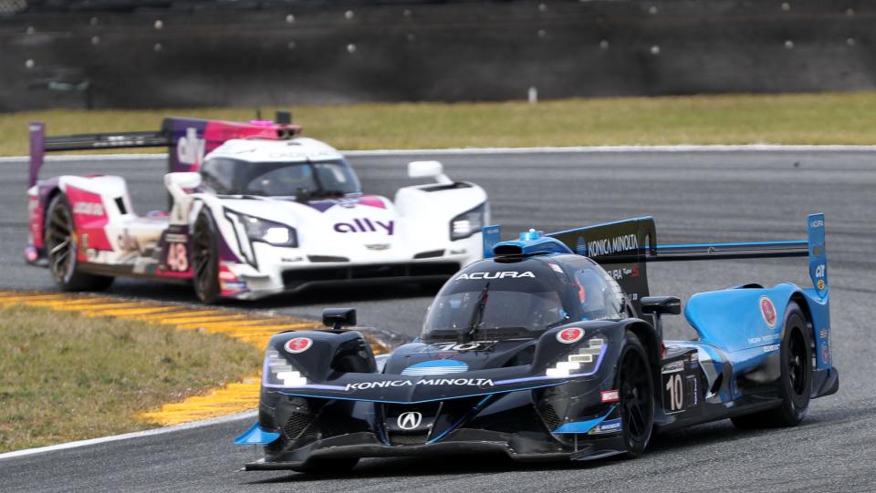 The no. 10 Acura DPi works through the east horseshoe ahead of the no. 48 Cadillac DPi, Friday January 21, 2022 during Weather Tech Championship practice at Daytona International Speedway.