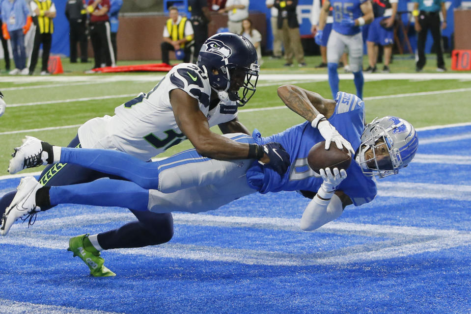 Detroit Lions wide receiver Josh Reynolds, defended by Seattle Seahawks cornerback Mike Jackson catches a 3-yard pass for a touchdown during the second half of an NFL football game, Sunday, Oct. 2, 2022, in Detroit. (AP Photo/Duane Burleson)