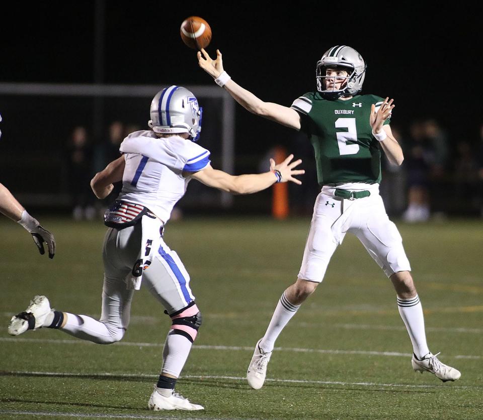 Dragons QB Matt Festa gets off a pass under pressure from Danvers #1 LB Jacob Westcott.Duxbury hosted Danvers football in MIAA playoff action on Friday November 12, 2021 