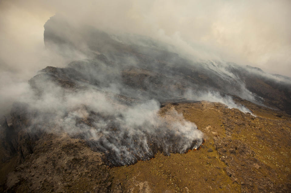 Fires burn across the slopes of Mount Kenya, the second-highest peak in Africa at 5,199 meters (17,057 feet), in Kenya Tuesday, March 20, 2012. Fires that have been raging across Mount Kenya may have been set by poachers trying to create a diversion from their illegal attacks on animals, a wildlife official said Tuesday. (AP Photo/Ben Curtis)