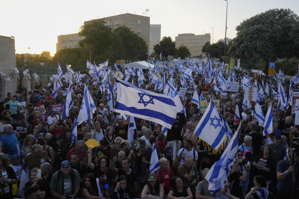 People take part in a protest against Israeli Prime Minister Benjamin Netanyahu's government, demanding new elections and the release of the hostages held in the Gaza Strip by the Hamas militant group, outside of the Knesset, Israel's parliament, in Jerusalem, Monday, June 17, 2024. (AP Photo/Ohad Zwigenberg)