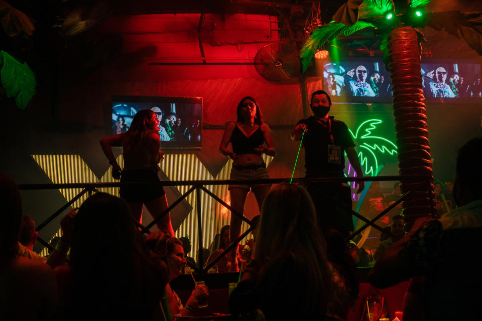 Revelers dance at a club in Cancún’s nightlife district on Oct. 17. Despite the pandemic still raging in Mexico, few tourists wear masks when packed together inside the city’s open-air clubs.<span class="copyright">Claudia Guadarrama—Magnum Foundation for TIME</span>