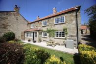 <p>Escape to North Yorkshire for a luxurious family break at this stunning cottage in the small village of Osmotherley. <a href="https://www.holidayathome.co.uk/accommodation/paddock-view/" rel="nofollow noopener" target="_blank" data-ylk="slk:Paddock View;elm:context_link;itc:0;sec:content-canvas" class="link ">Paddock View</a> is a self-catering property from luxury cottage rental site Holiday at Home, which affords all the comforts of home, such as log burners, board games and a perfectly preened garden, alongside the unexpected touches you'd normally find in a hotel. </p><p>Here, you can enjoy spa-style robes, miniature toiletries and a rain shower in one of the bathrooms, as well as an AGA to entertain the family with delicious feasts. When the weather permits, you'll want to head out to the garden and fire up the pizza oven and BBQ. With enough room for eight, it's perfect for a multi-generational holiday. The grandparents will love relaxing in the pretty garden, while the teens won't get bored thanks to the table football and Xbox in the games room.</p><p>With Farrow & Ball paint, sumptuous beds and high-quality decor throughout (we love the kitchen island with bar stools and elegant dining room), this cottage was designed to impress the whole family, including furry members with four legs.</p><p>Nearby, there's an abundance of walking trails and beauty spots, like Cod Beck Reservoir. For days out, Whitby, York and Harrogate are worth considering when you're not soaking up the village atmosphere in Osmotherley.</p><p><a class="link " href="https://www.holidayathome.co.uk/accommodation/paddock-view/" rel="nofollow noopener" target="_blank" data-ylk="slk:BOOK A STAY;elm:context_link;itc:0;sec:content-canvas">BOOK A STAY</a> </p>