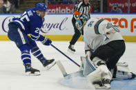 Toronto Maple Leafs forward Ondrej Kase (25) scores on San Jose Sharks goaltender Adin Hill (33) during the second period of an NHL hockey game Friday, Oct. 22, 2021, in Toronto. (Evan Buhler/The Canadian Press via AP)