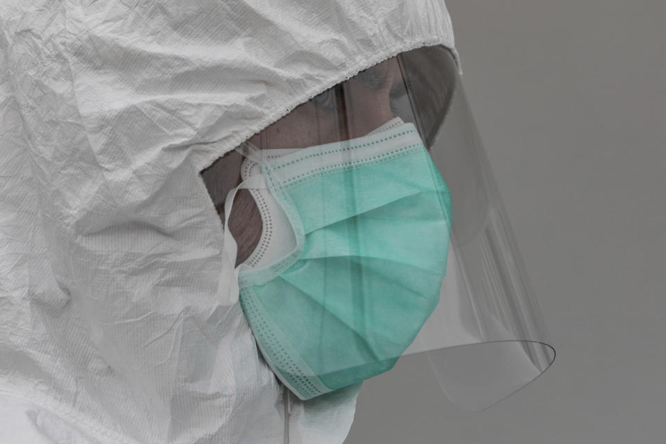 A healthcare worker wears protective gear during the coronavirus outbreak in Madrid, Spain, Monday, March 30, 2020. Bells tolled in Madrid's deserted central square and flags were lowered in a day of mourning Monday as Spain raced to build field hospitals to treat an onslaught of coronavirus patients. The new coronavirus causes mild or moderate symptoms for most people, but for some, especially older adults and people with existing health problems, it can cause more severe illness or death. (AP Photo/Bernat Armangue)