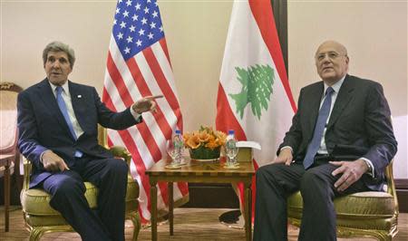 U.S. Secretary of State John Kerry (L) gestures to Lebanese Prime Minister Najib Mikati (R) before their meeting at the Syrian Donors Conference at the Bayan Palace in Kuwait City January 15, 2014. REUTERS/Pablo Martinez Monsivais/Pool