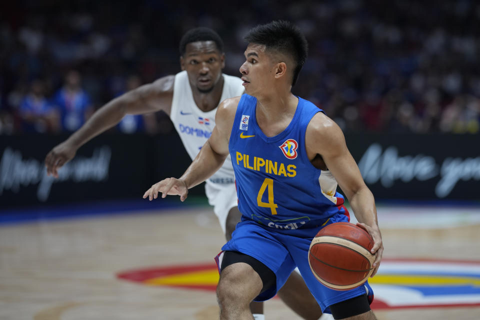 Philippines guard Kiefer Ravena (4) and Dominican Republic guard Jean Montero (3) during their match at the Basketball World Cup at the Philippine Arena in Bulacan province, Philippines Friday, Aug. 25, 2023. (AP Photo/Aaron Favila)