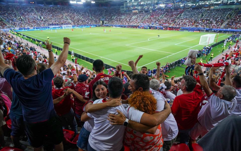 Fans of Sevilla celebrate after Yousseff En-Nesyri of Sevilla scores