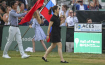 Tennis Hall of Fame inductee Li Na, of China, waves to the crowd as she is introduced during ceremonies at the International Tennis Hall of Fame, Saturday, July 20, 2019, in Newport, R.I. (AP Photo/Stew Milne)