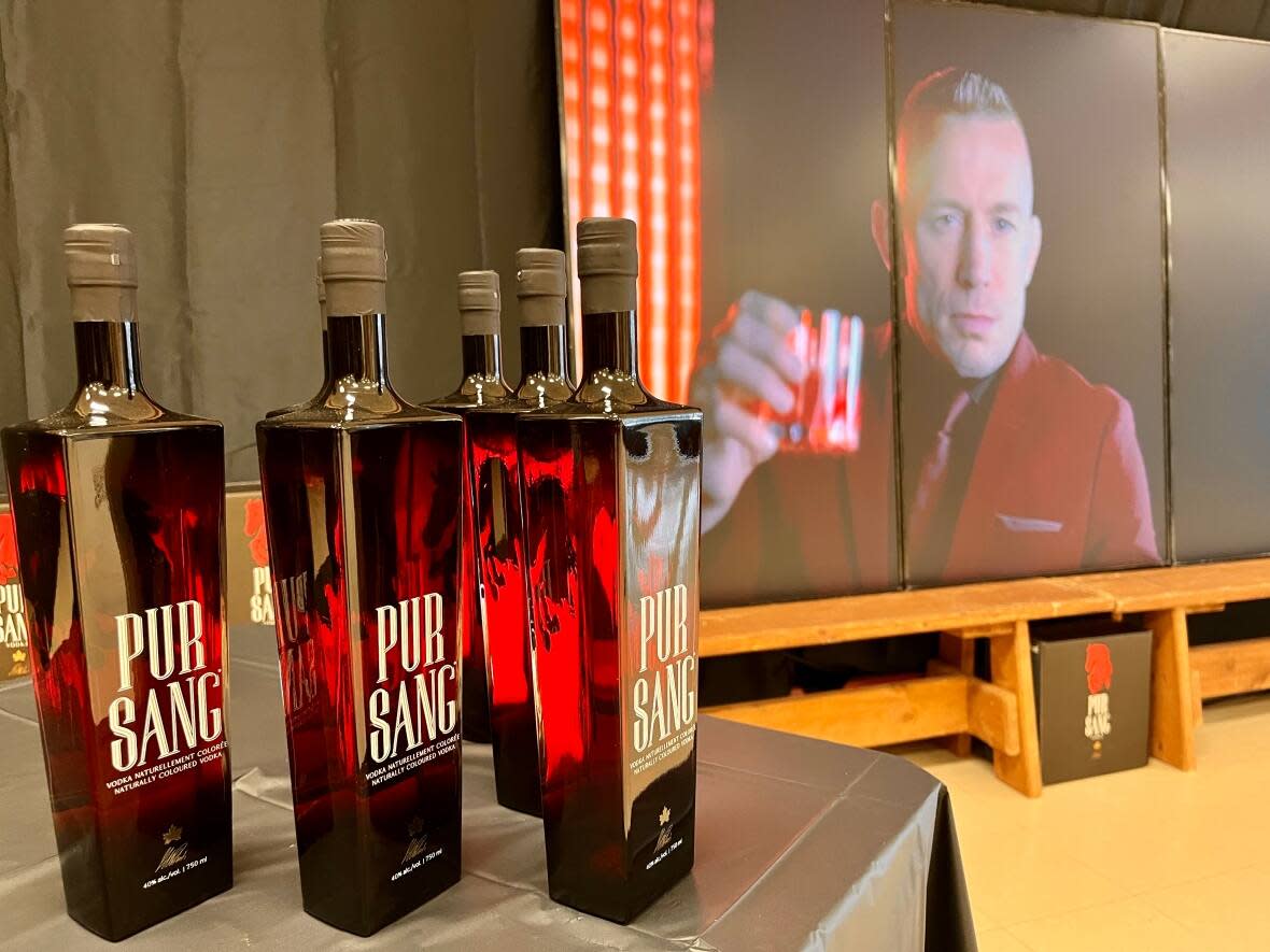 A video of Georges St-Pierre plays at the NLC's Rock Spirits distillery promoting his new vodka Pur Sang.  (Jeremy Eaton/CBC - image credit)