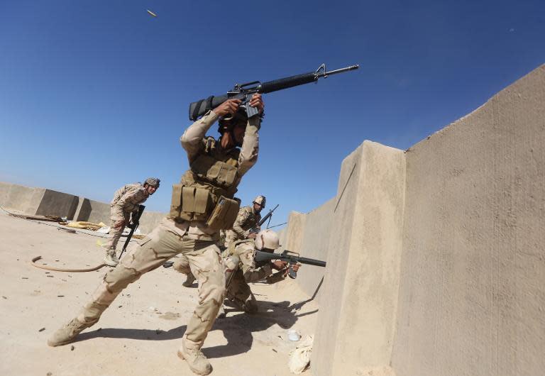 Iraqi soldiers fire towards Islamic State group positions in the Garma district, west of the Iraqi capital Baghdad, on April 26, 2015