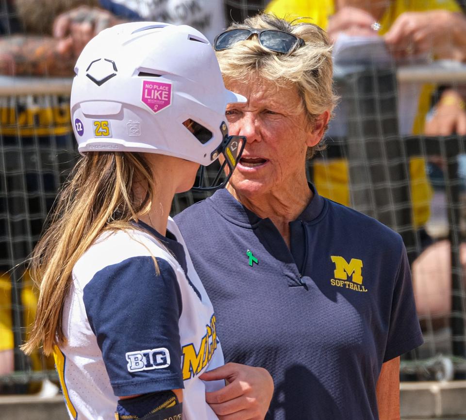 With players in scoring position, Michigan Head Softball Coach Carol Hutchins talks with Audrey LeClair (25) before she bats in the Big Ten Softball Championship Game at Secchia Stadium Saturday, May 14, 2022. 