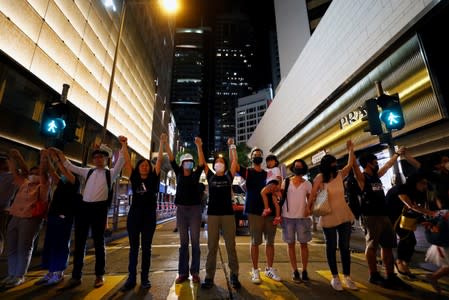 Protesters hold hands to form a human chain during a rally to call for political reforms in Hong Kong's Central district