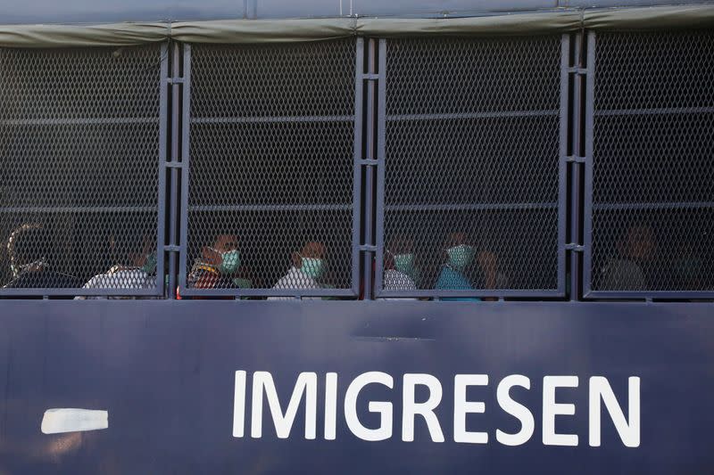 FILE PHOTO: Myanmar migrants to be deported from Malaysia are seen inside an immigration truck, in Lumut