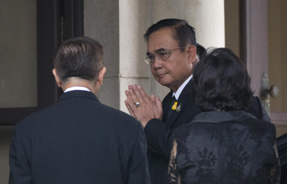 Thailand's Prime Minister Prayuth Chan-ocha, center, arrives at government house in Bangkok, Thailand, Thursday, June 6, 2019. Thailand's Parliament elected 2014 coup leader Prayuth Chan-ocha as prime minister in a vote Wednesday that helps ensure the military's sustained dominance of politics since the country became a constitutional monarchy nearly nine decades ago. (AP Photo/Sakchai Lalit)